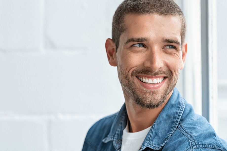 man smiling while looking away