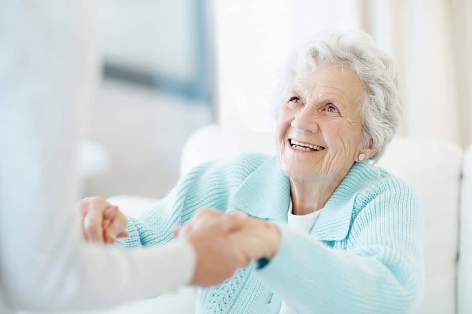 senior woman getting help standing up