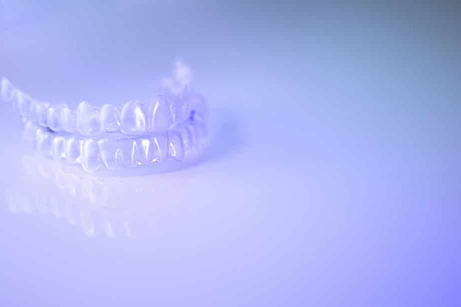 invisalign retainer sitting on a reflective surface