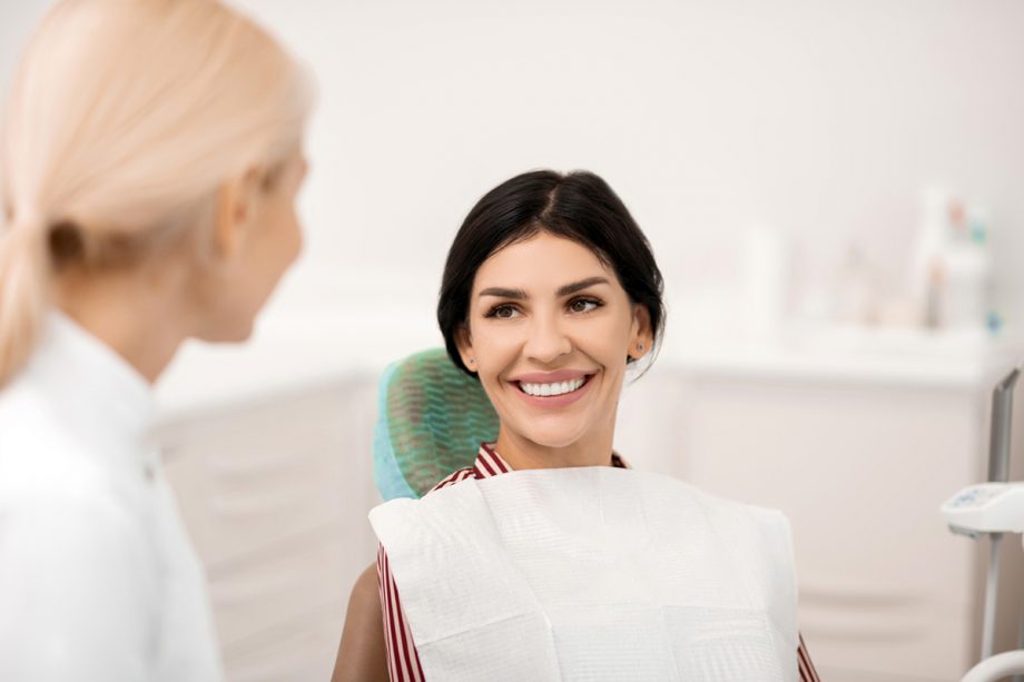 female dentist consulting with female patient