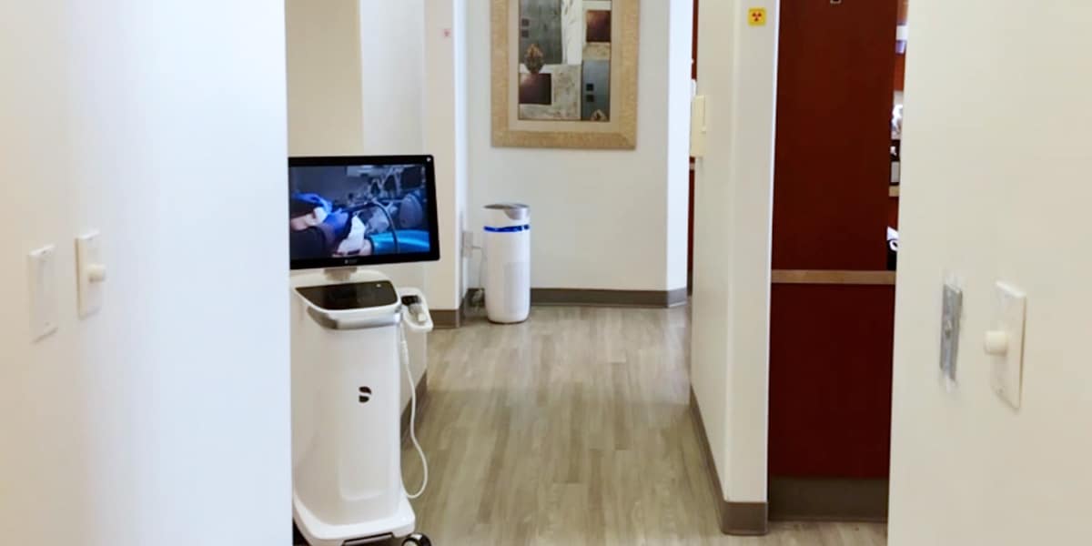 hallway in dental office with white walls and laminate floors